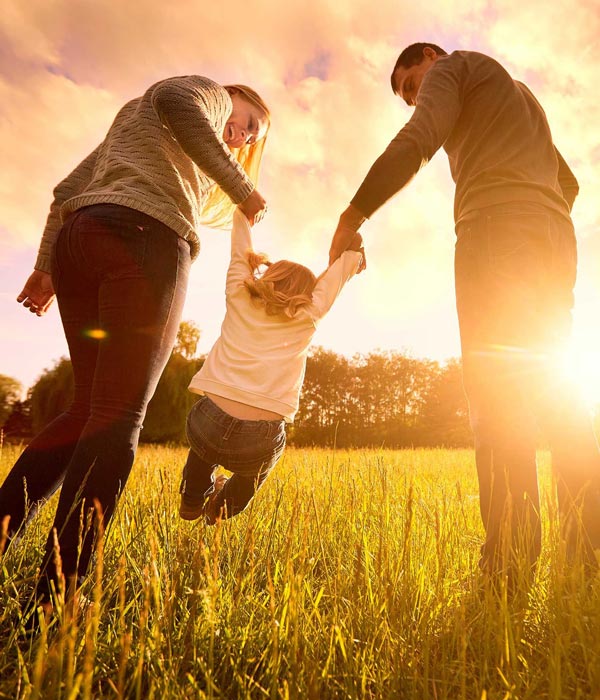 happy family of 3 in the sun